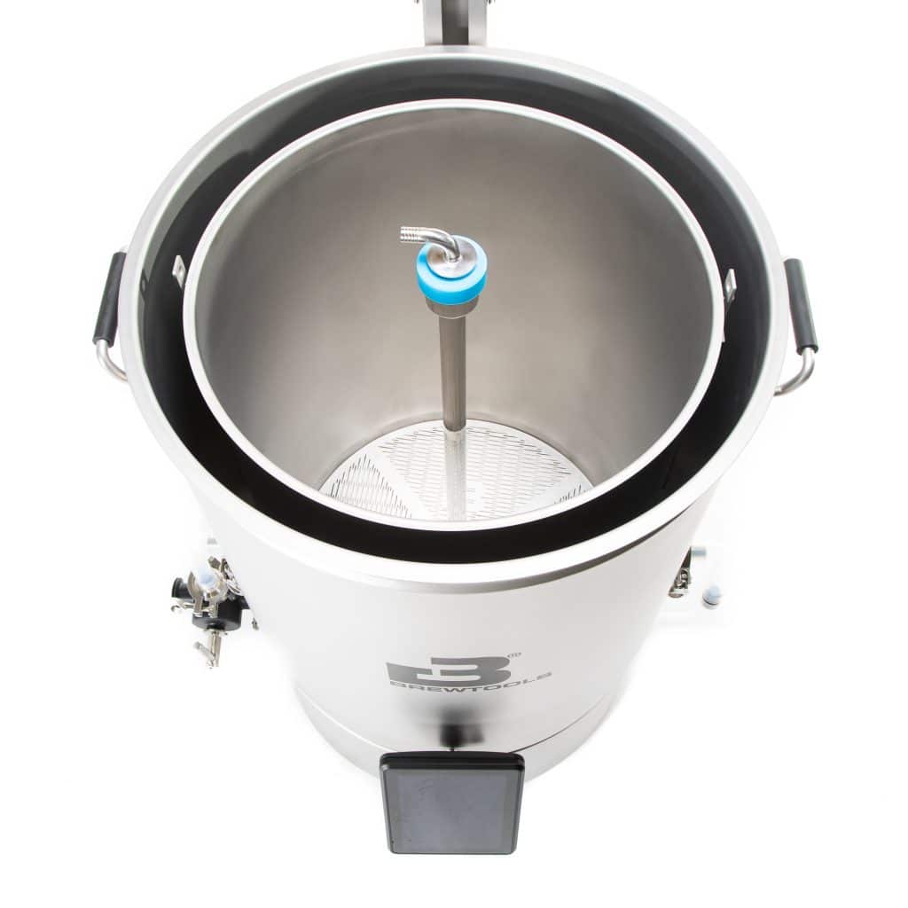 Top-down view of a stainless steel brewing kettle with a central vertical tube and blue component inside, seen from above