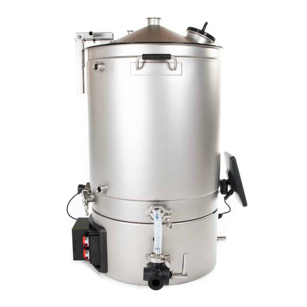 Industrial stainless steel pressure vessel with various valves, gauges, and a mounted control panel on the side.