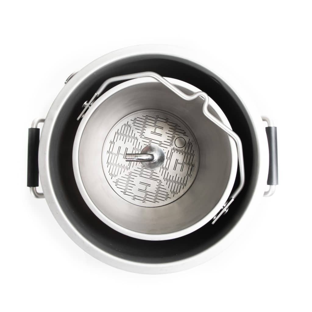 Close-up of a metallic headphone earcup showing the perforated grille and inner padding