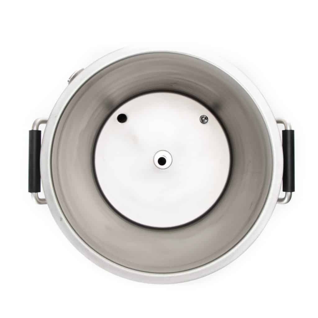 Top view of a stainless steel pressure cooker lid with black handles on the sides, showing inner rim and vent openings.
