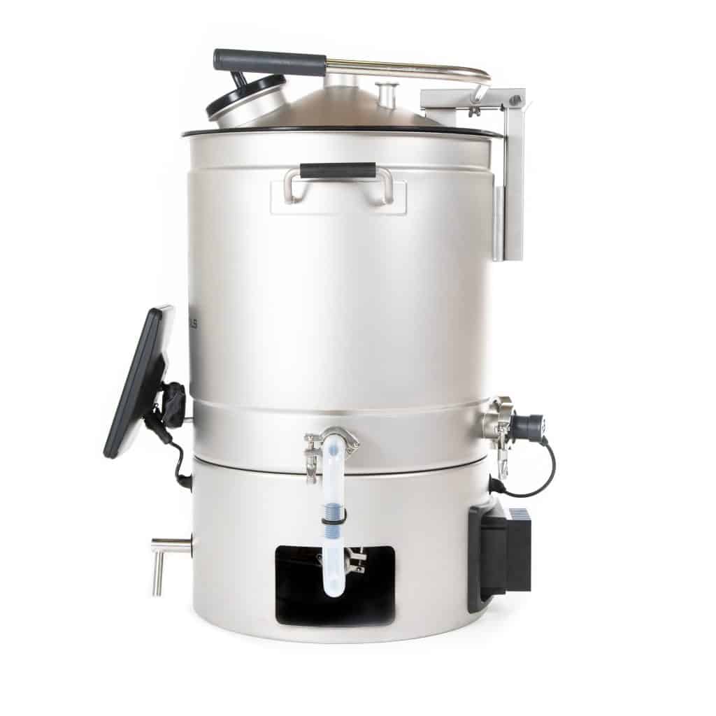Close-up of a large stainless steel industrial kettle with a hinged lid, clamps, and mounting hardware attached to a frame