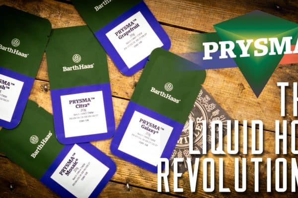 Several green and blue BarthsHaas cards scattered on a wooden table, with bold white text 'THE LIQUID HOP REVOLUTION?' and a triangular PRYSM A graphic in the corner