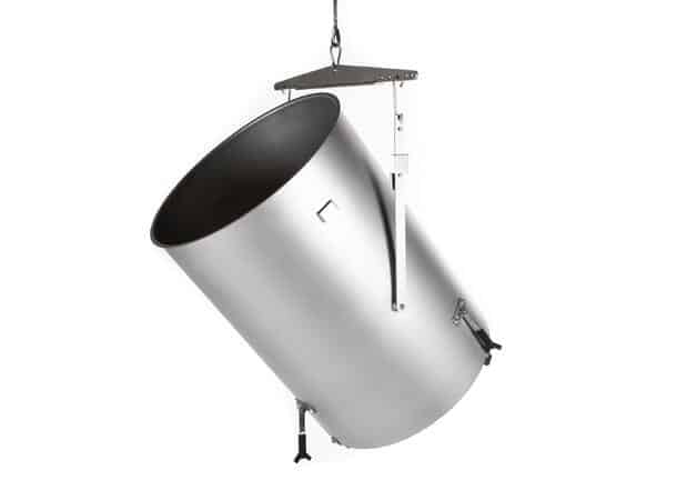 Industrial stainless steel cylindrical tank suspended by a crane with hooks and chains