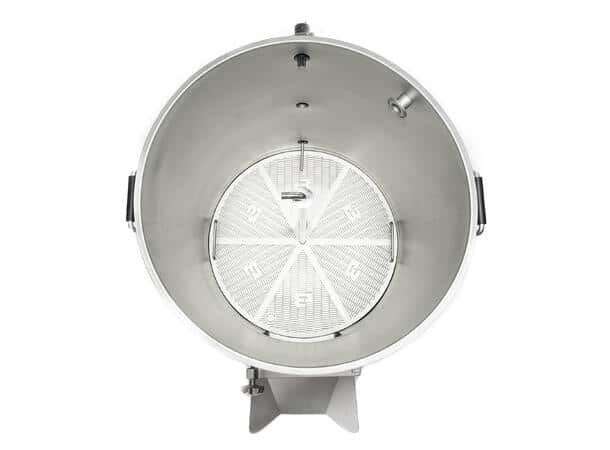 Top-down view of a large stainless steel cylindrical drum with a perforated circular tray inside and side handles.